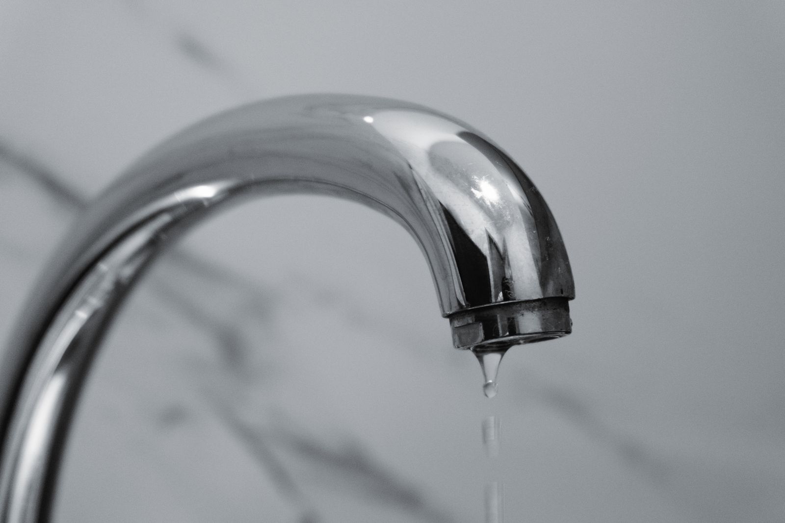 Dripping tap – licensed stock Water dripping from a chrome tap